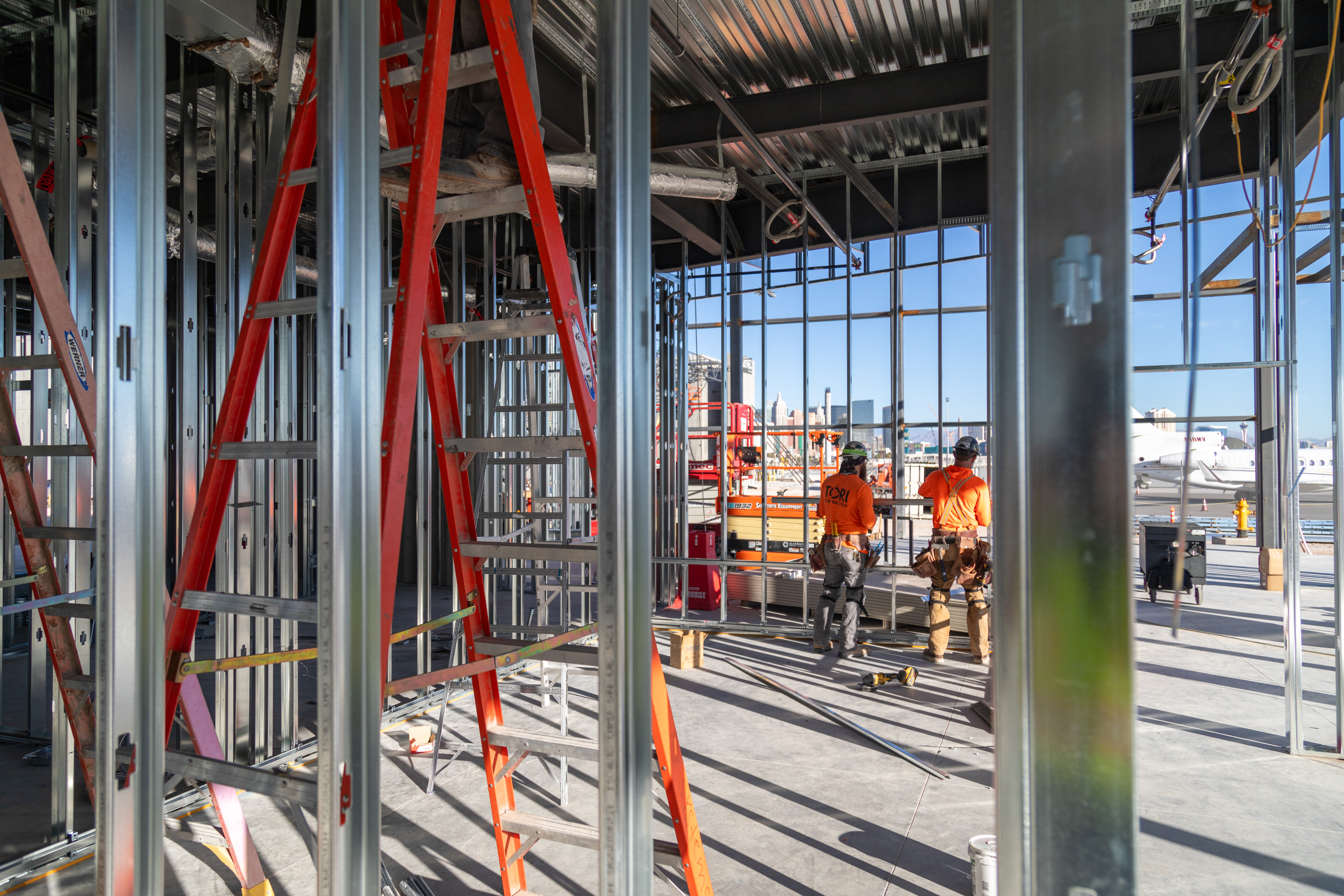 Tori Contracting crew working inside metal stud framing on a commercial build
